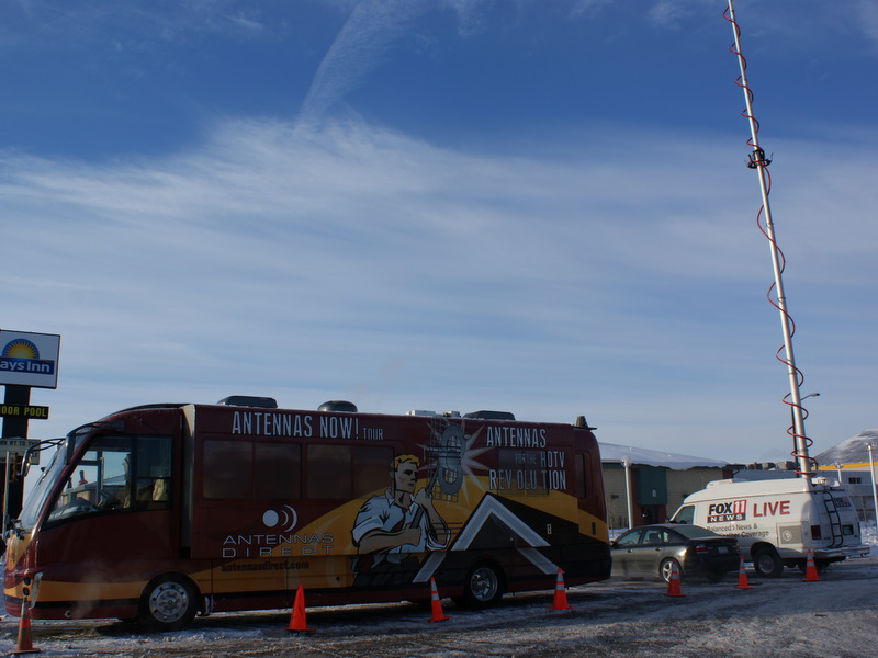 Results image of tour bus with Fox 11 van Green Bay, WI