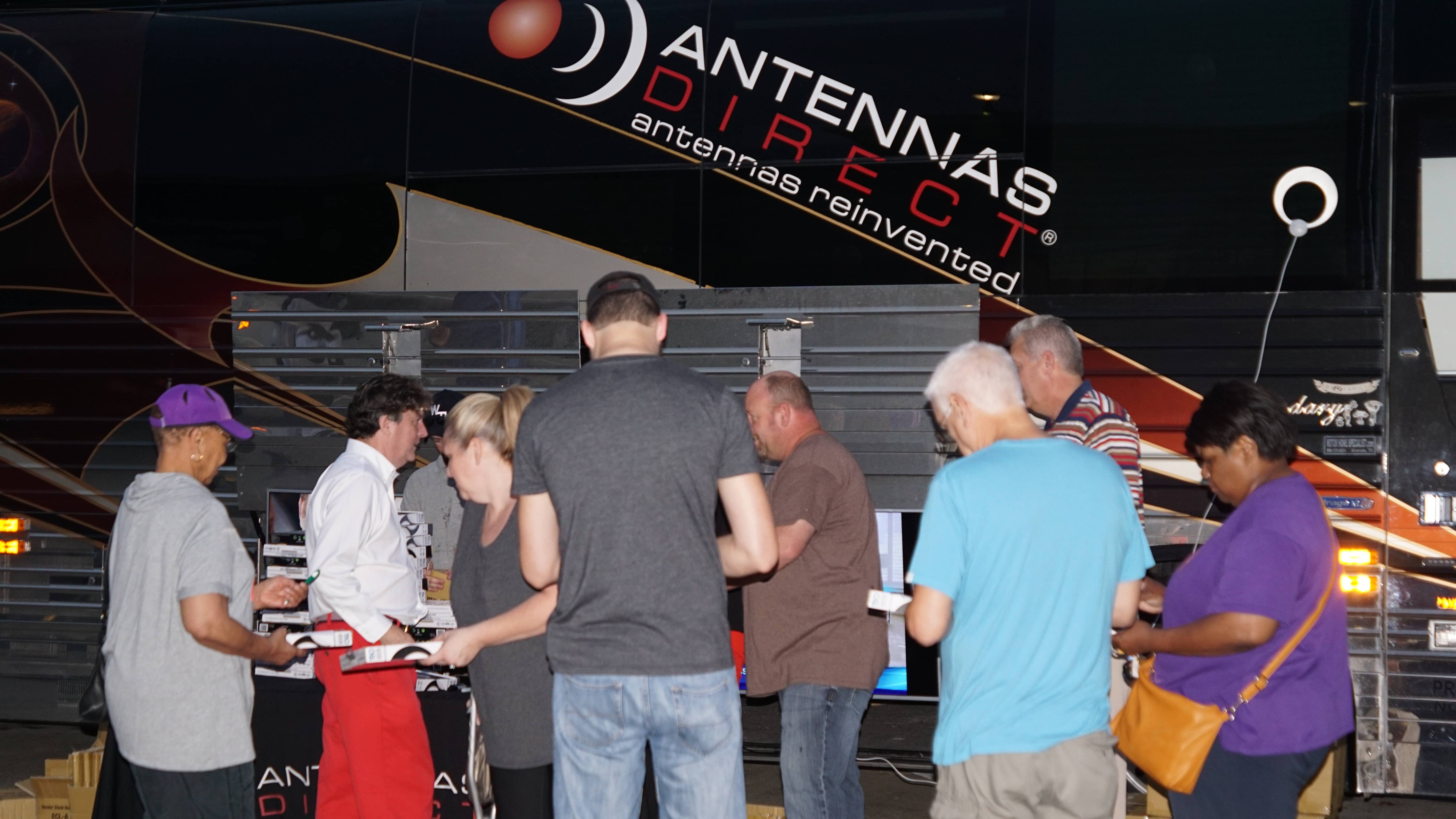 Results image of Little Rock group in front of Antennas Direct bus for antenna giveaway