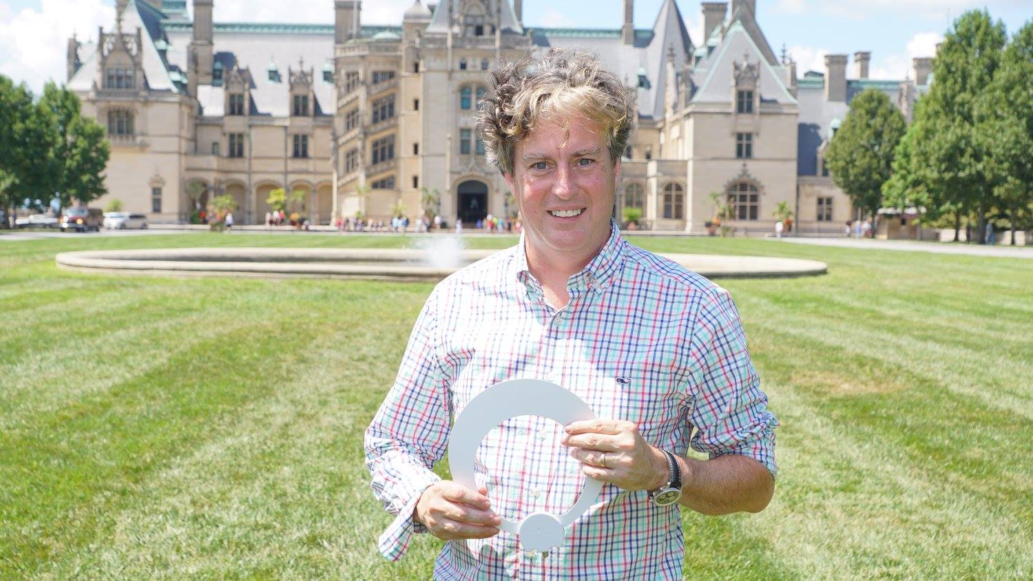 Results image of President Richard Schneider holding Eclipse antenna