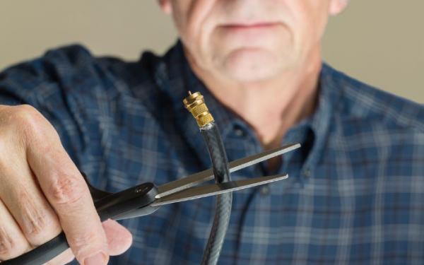 Results image of man cutting cord with scissors