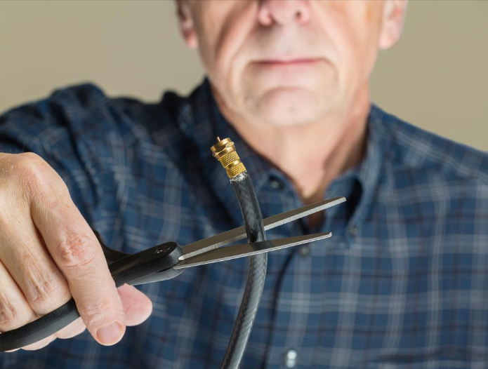 Results image of man cutting cord with scissors