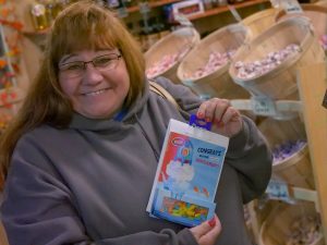 Antennas Direct team member holding a box of candy