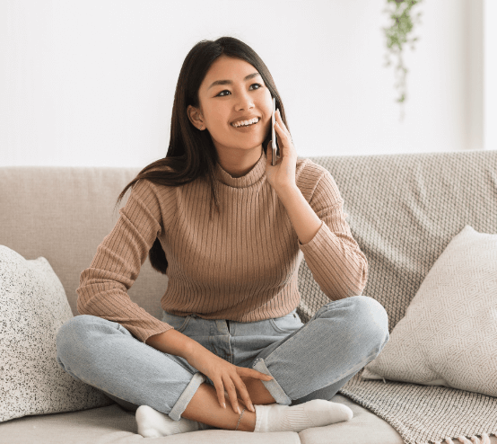 sitting on the couch smiling
